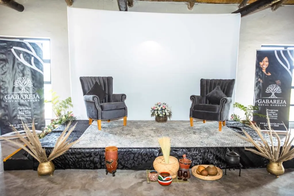 Stage set with wingback chairs for a traditional ceremony