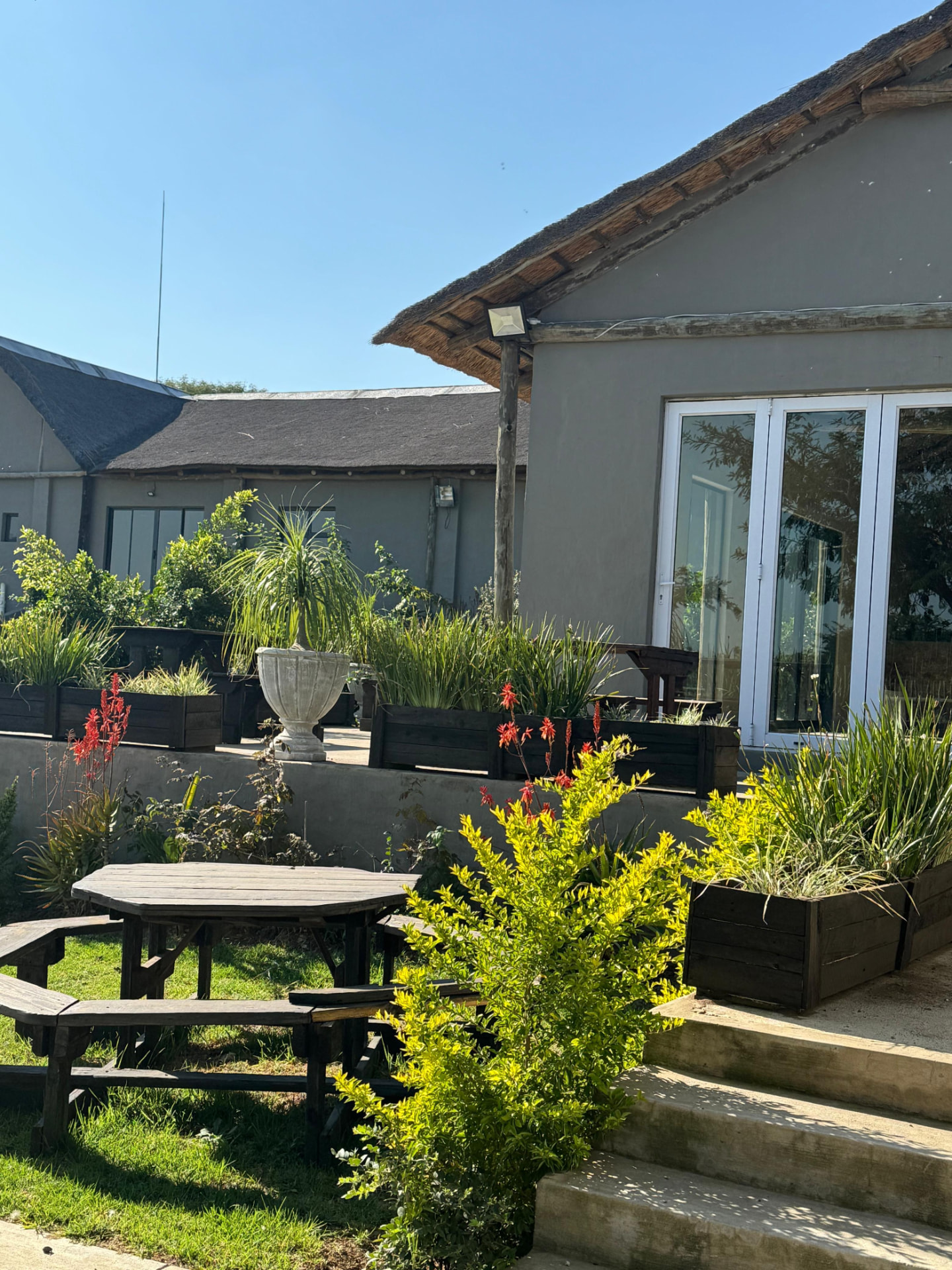 Terrace seating and planters outside the lodge